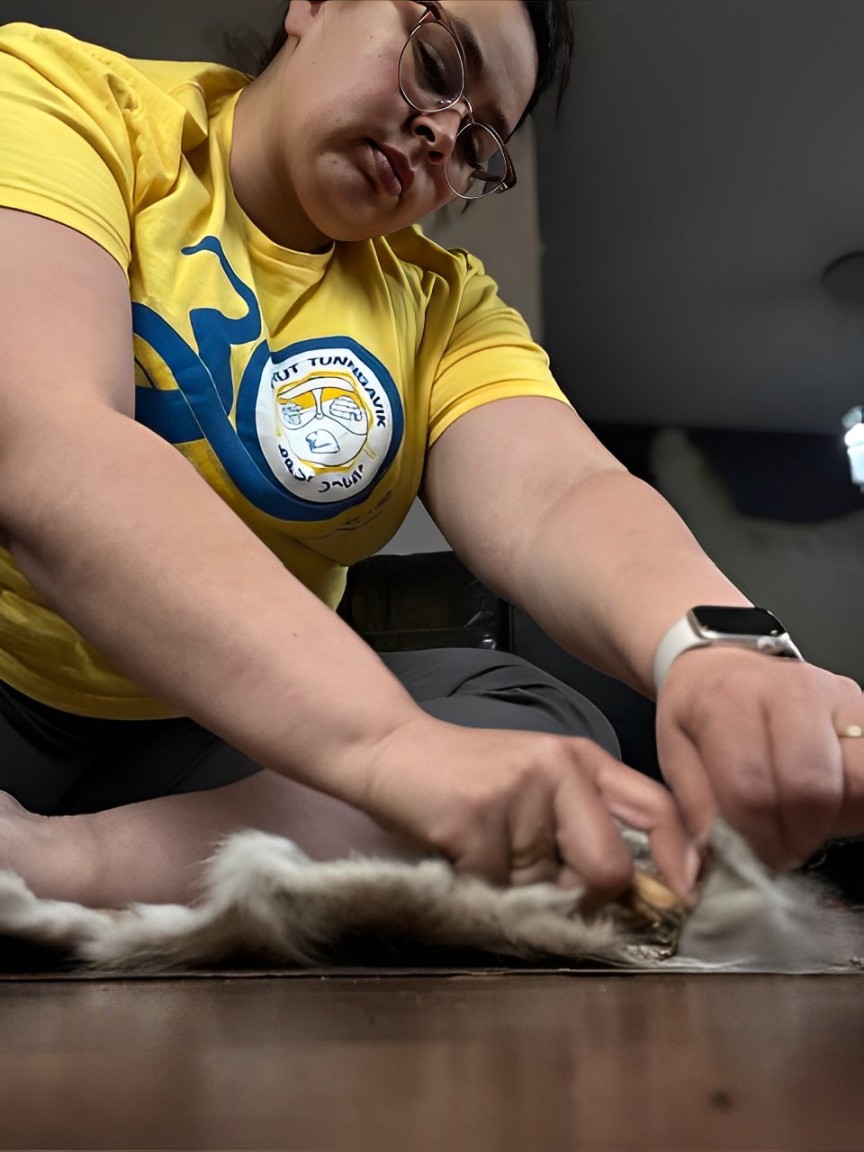 Image provided by Ashley Tulugak Woman working with animal fur